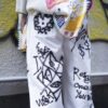 "Wall Paint" prophecy motif white baggy remake pants