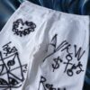 "Wall Paint" prophecy motif white baggy remake pants